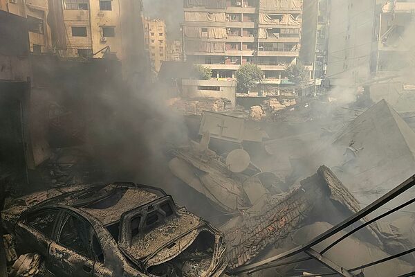 Humo entre los restos de un edificio destruido de Beirut por un bombardeo israelí.